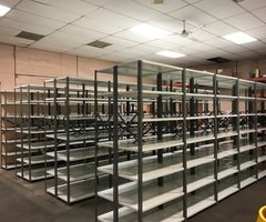 Rows of used steel clip shelving