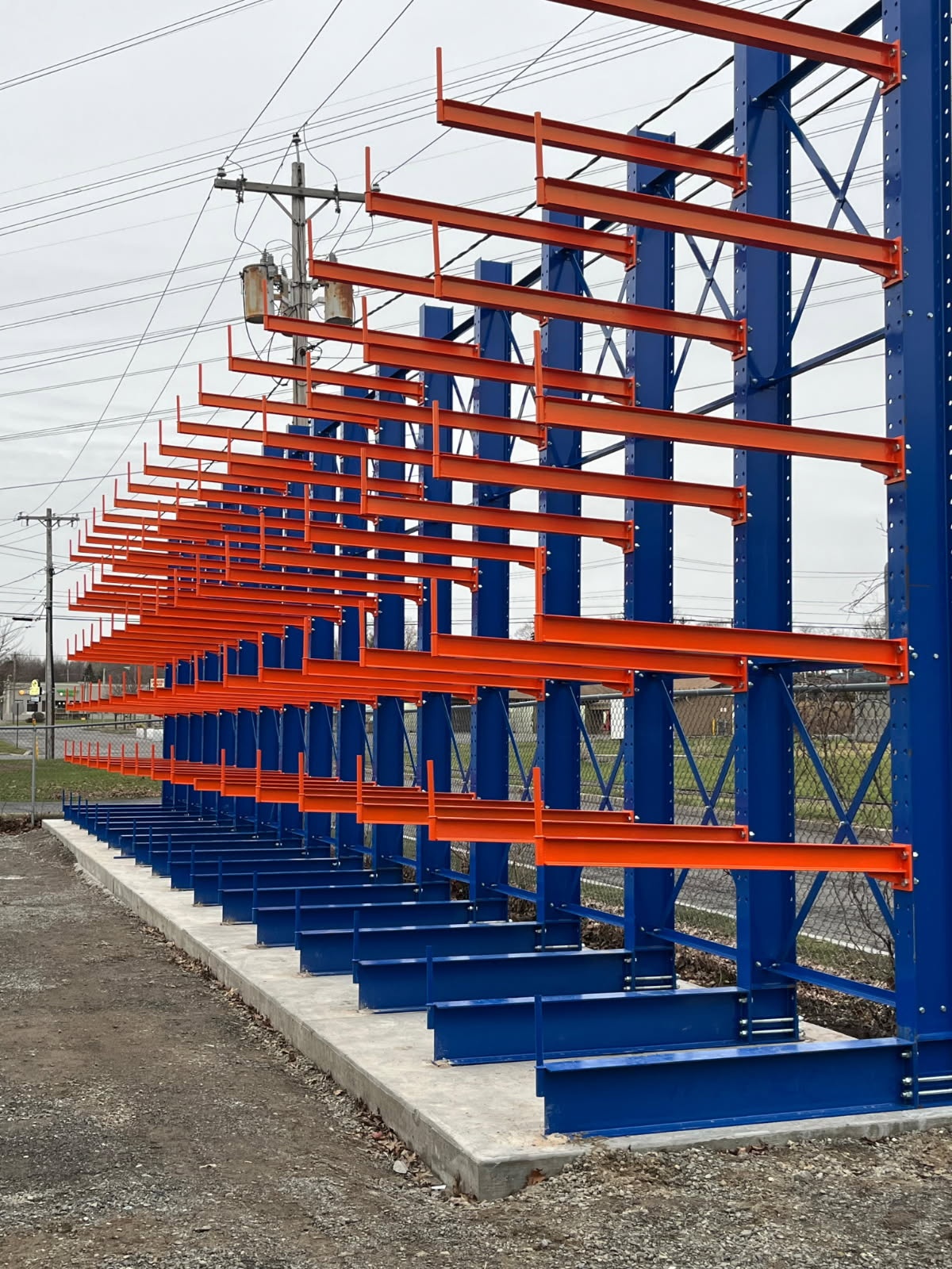 Cantilever rack system loaded with long steel bar stock at an Oswego New York warehouse