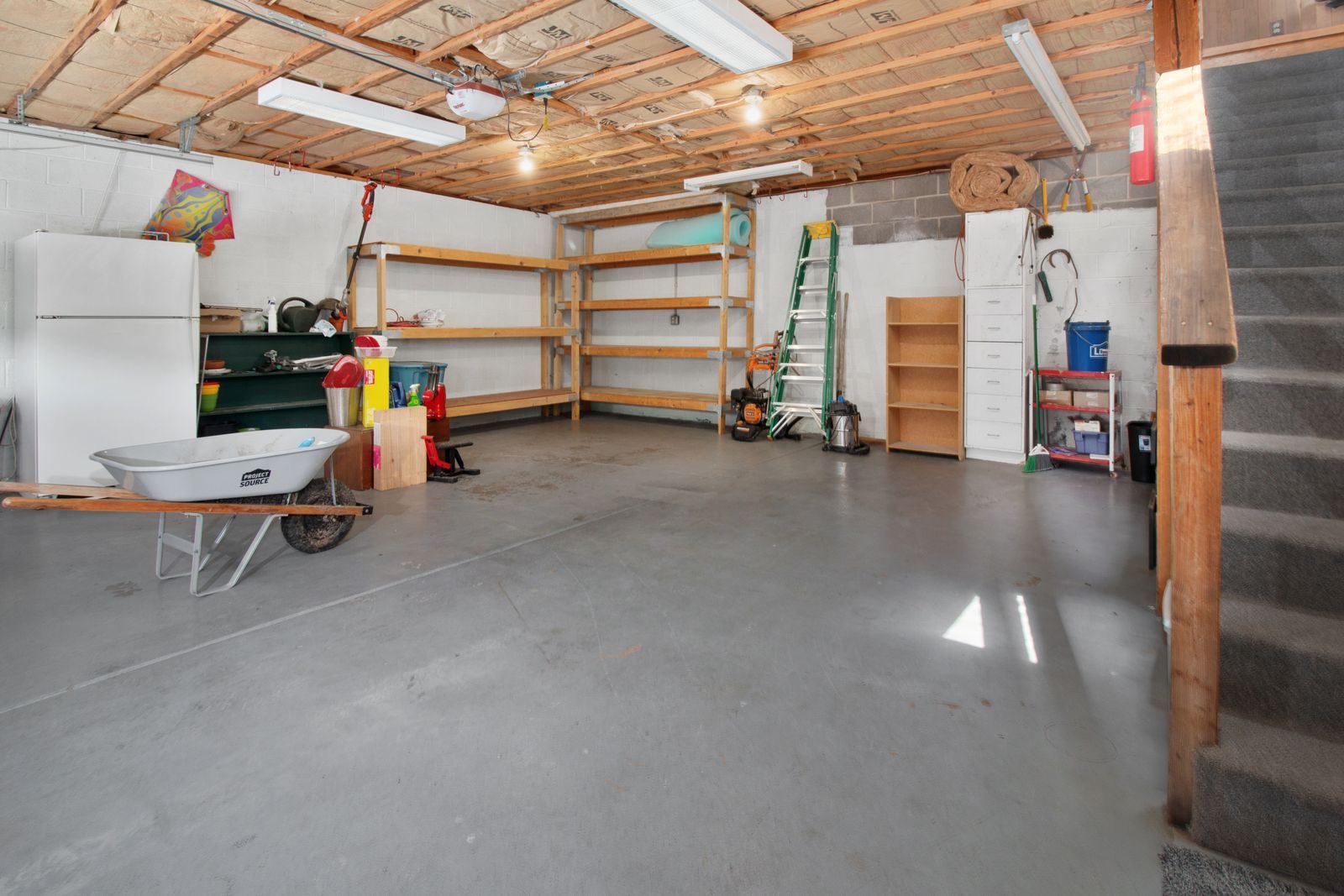 Garage with wall-mounted storage shelving