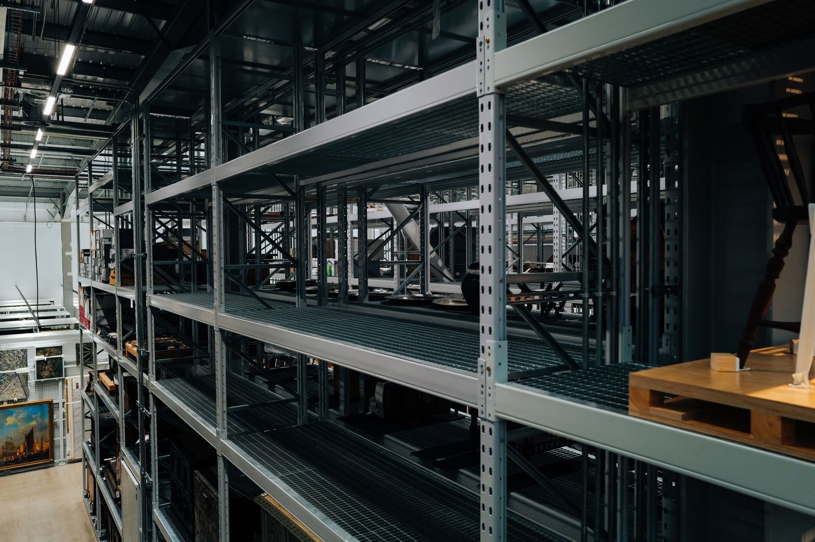 Steel rack uprights standing on a warehouse concrete floor